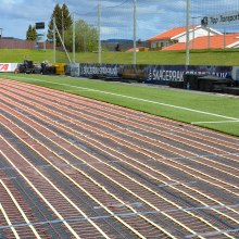 Heating of playing surfaces with artificial grass.